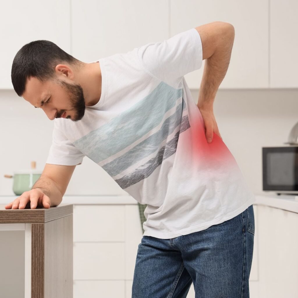 The man in this image bend towards one on hand his table and other on his back stress area