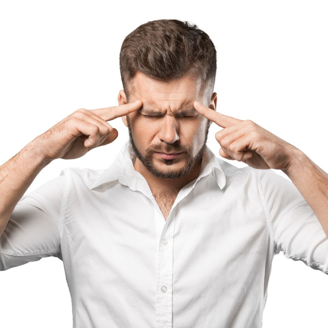 Person with eyes closed pressing temples while experiencing brain fog, mental fatigue, difficulty concentrating, and low mood associated with immune dysregulation.