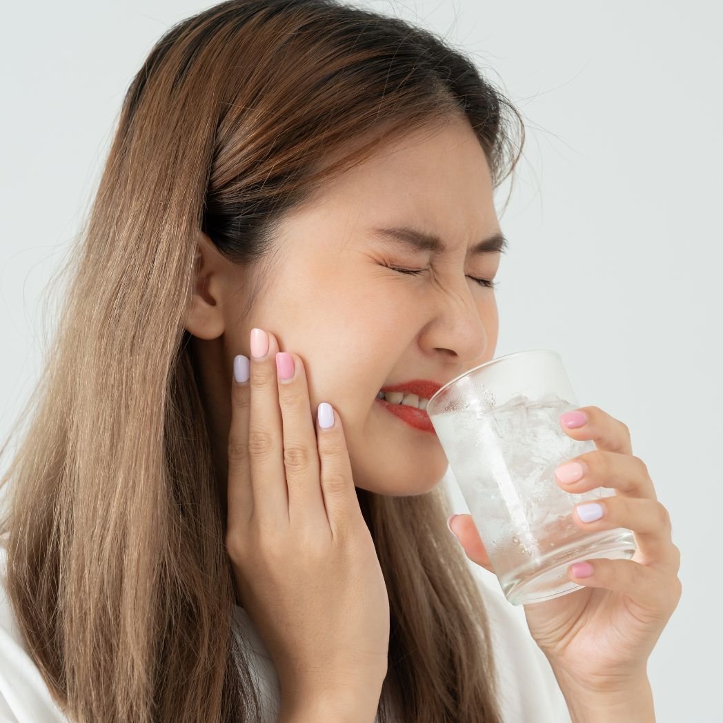 Woman experiencing seasonal sensitivities and facial discomfort associated with immune dysregulation symptoms.