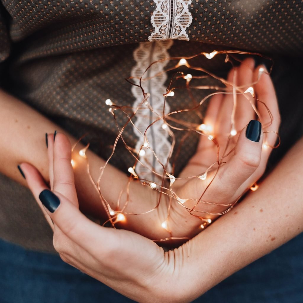 Hands holding healing energy crystals representing mind-body wellness and holistic healing