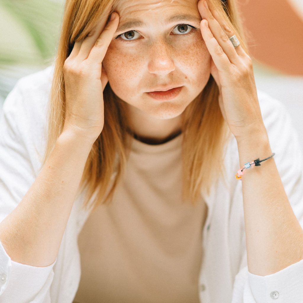 Individual experiencing symptoms of chronic stress and emotional burnout